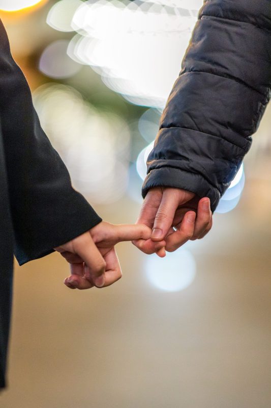 Two-people-holding-each-others-hands